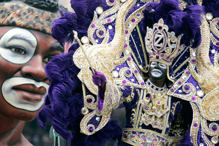 King Zulu waves to revelers as he parades down St. Charles Avenue Mardi Gras Day in New Orleans, Louisiana February 20, 2007.