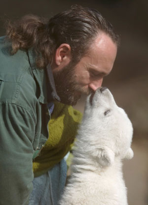 Berlin zoo employee Thomas Doerflein plays with polar bear cub Knut during the bear's first presentation in Berlin zoo, March 23, 2007. 